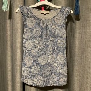 blue and white tank top with ruffles on shoulder.